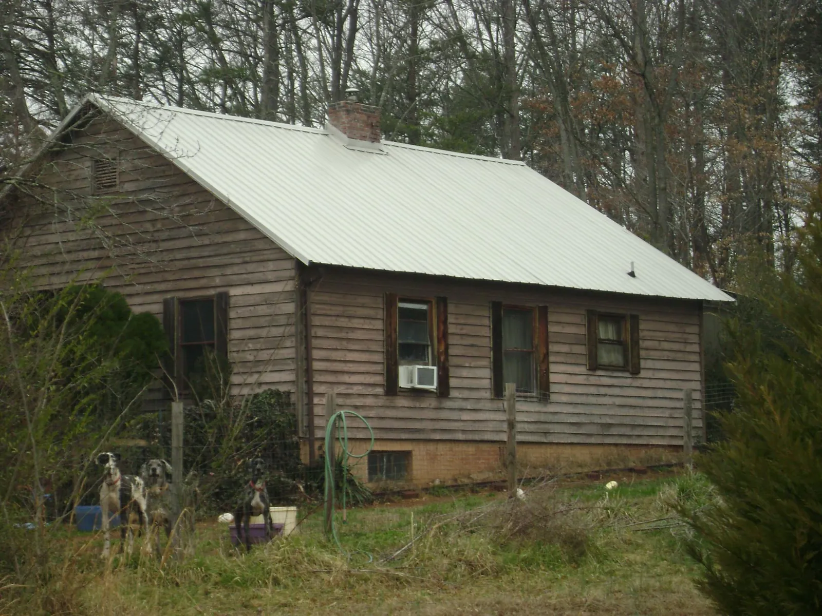 White metal roof on an old wood sided farmhouse, from a Metal Roof Installation job in Manilla